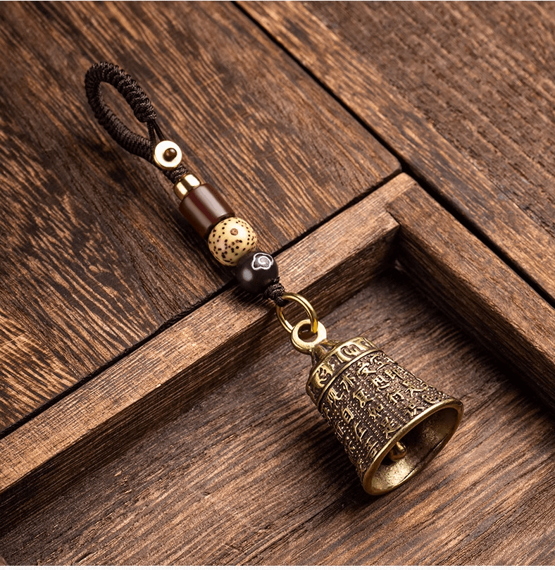 PRAJNA PARAMITA SUTRA Buddha Clock wind chimes Pendant featuring a bronze bell on a wooden background.